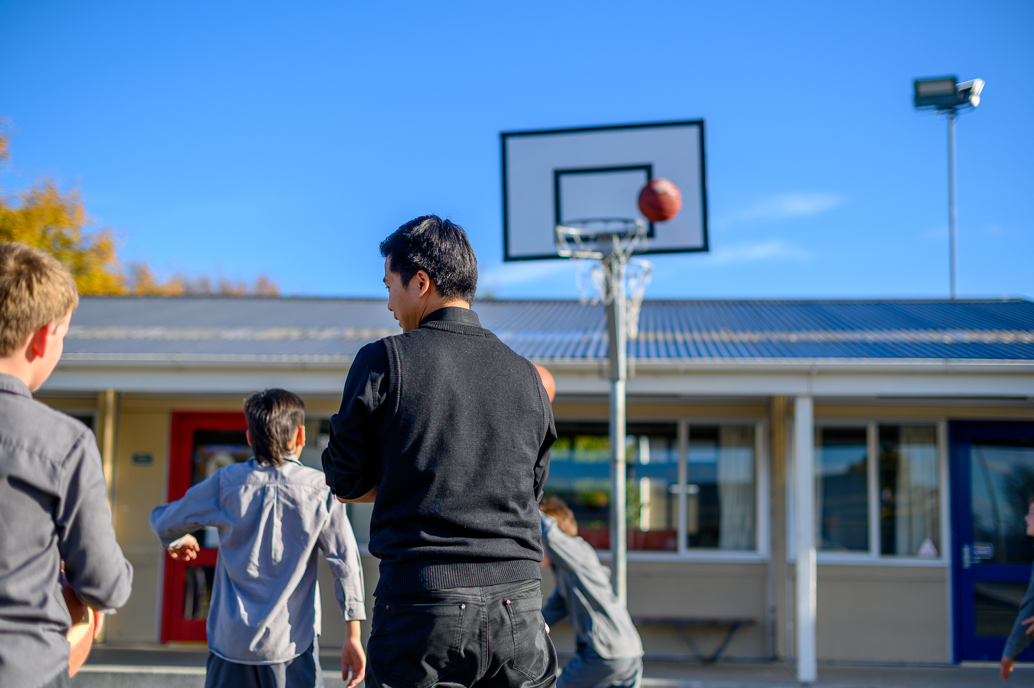 School Boys and Fr Tien Playing Basketball RSZ