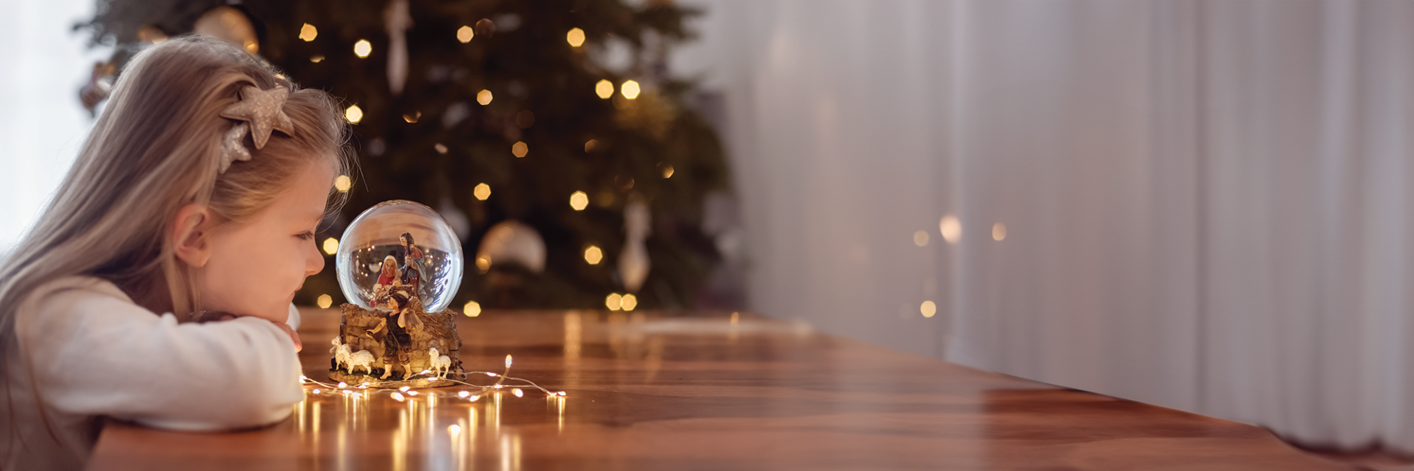 Girl looking at snowglobe