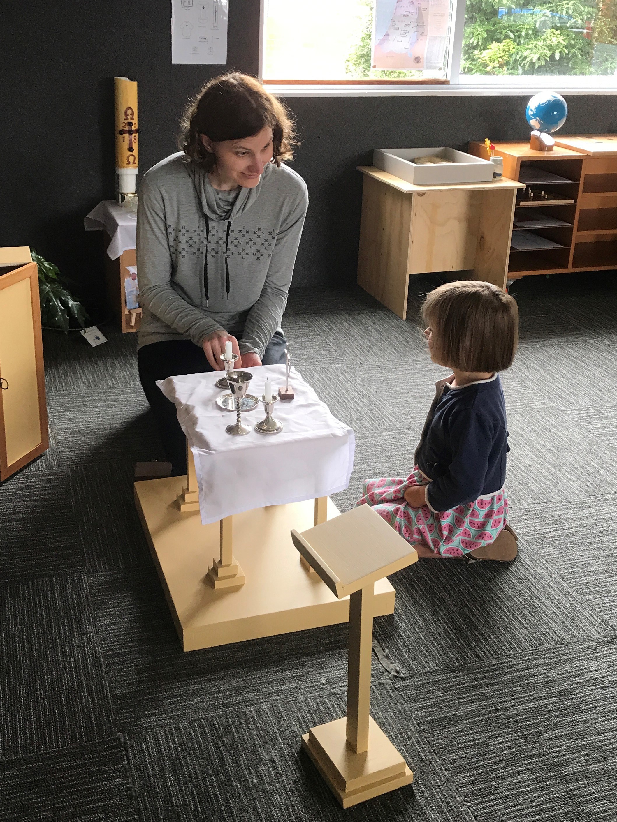 Child waiting for Katherine the catechist to light the candles having prepared the altar