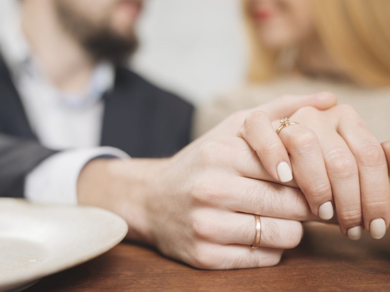 Closeup woman man holding hands